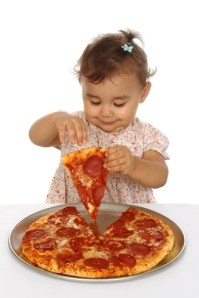 Toddler eating pizza